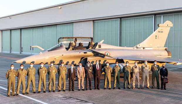 Indian jetfighters pilots, Dassault Aviation CEO Eric Trappier (8thL) next to Shri Ambassador of India to France Jawed Ashraf (7thL), and officials posing before an Indian Air Force Rafale aircraft at Merignac air base, southwestern France. AFP/Dassault Aviation/V. Almansa