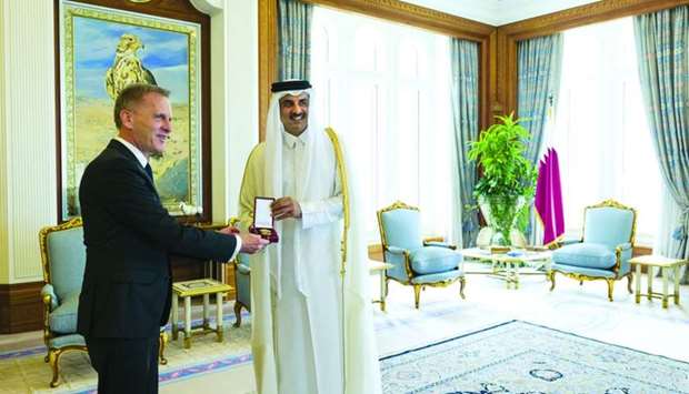 His Highness the Amir Sheikh Tamim bin Hamad al-Thani grants ambassador Hans-Udo Muzel Al Wajbah Decoration