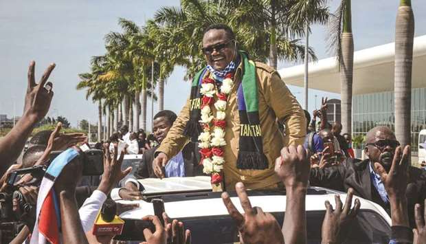 Tundu Lissu (centre), Tanzaniau2019s former MP with the Chadema main opposition party, who was shot 16 times in a 2017 attack, reacts to supporters as he returns after three years in exile to challenge President John Magufuli in elections later this year, at Julius Nyerere International Airport in Dar es Salaam, yesterday.