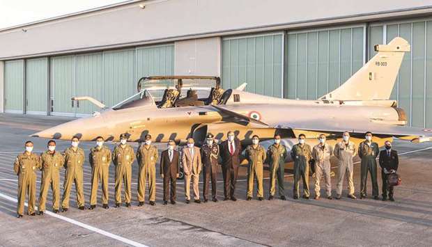 A handout picture released yesterday by Dassault Aviation shows IAF pilots, Dassault Aviation CEO Eric Trappier (eighth left), Indian ambassador Jawed Ashraf (seventh left), and officials posing before an Indian Air Force Rafale aircraft at Merignac air base, southwestern France.