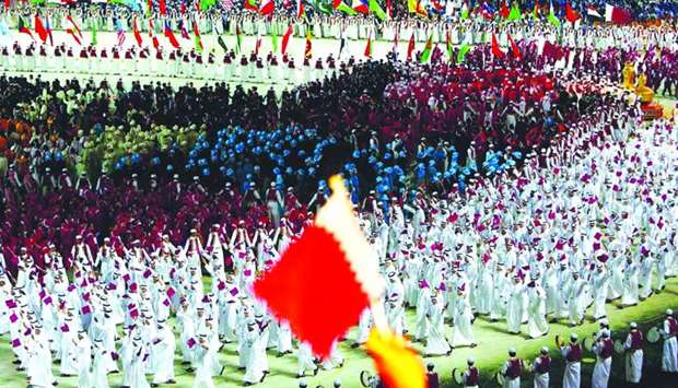 Athletes of Qatar parade into the stadium during the Opening Ceremony of the 15th Asian Games Doha 2006 at the Khalifa stadium on December 1, 2006