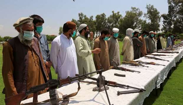 Members of the Taliban handover their weapons and join in the Afghan government's reconciliation and reintegration program in Jalalabad, Afghanistan June 25, 2020