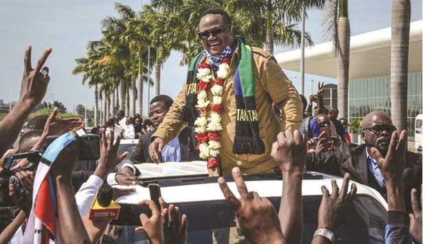 Tundu Lissu (centre), Tanzaniau2019s former MP with the Chadema main opposition party, who was shot 16 times in a 2017 attack, reacts to supporters as he returns after three years in exile to challenge President John Magufuli in elections later this year, at Julius Nyerere International Airport in Dar es Salaam, yesterday.