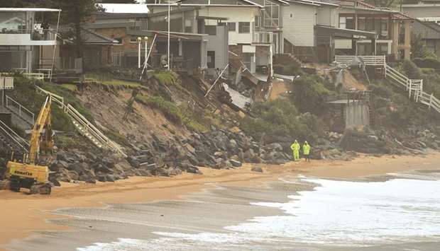Erosion is seen under homes perched on Australiau2019s eastern coastal town of Wamberal that are at risk of being swept away yesterday, after days of driving rain, high winds and monster swells smashed the coastline.