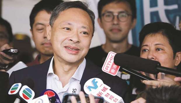 In this file photo, Benny Tai speaks to the media as he leaves the high court after being released on bail in Hong Kong.