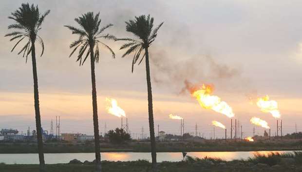 Flames emerge from flare stacks at the oil fields in Basra, Iraq (file). Chronic power outages combined with low oil prices threaten Iraqu2019s political stability, and Opecu2019s second-biggest producer must act fast to boost electricity supply or face a new crisis within the next two months, according to Fatih Birol, the head of the International Energy Agency.