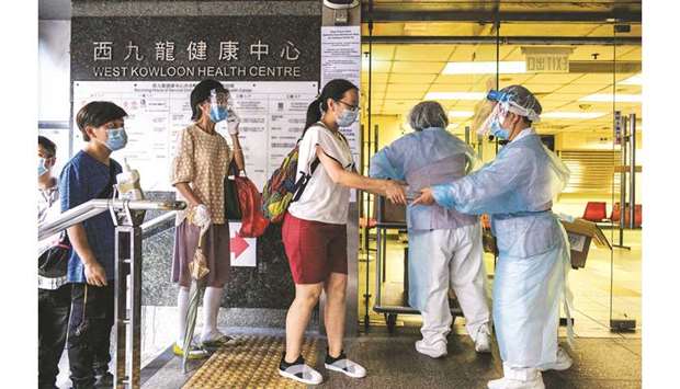 Residents are given free Covid-19 coronavirus test kits by workers at a government clinic in the Kowloon-side Sham Shui Po district of Hong Kong.