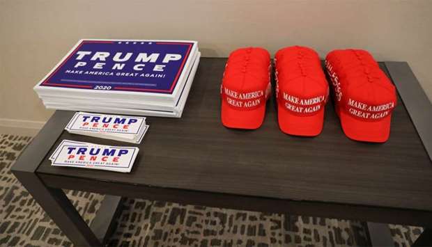Trump re-election campaign signs and u2018Make America Great Againu2019 hats sit on a table outside a campaign fundraiser in Texas