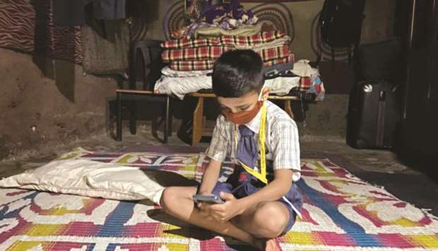 Gautam Suresh attends an online class at his home in suburban Mumbai, India.