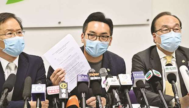 Civic Party leader Alvin Yeung shows his disqualification notice during a press conference at the party headquarters in Hong Kong yesterday after a dozen local democracy activists, including Yeung, were disqualified from standing in Septemberu2019s legislative elections.