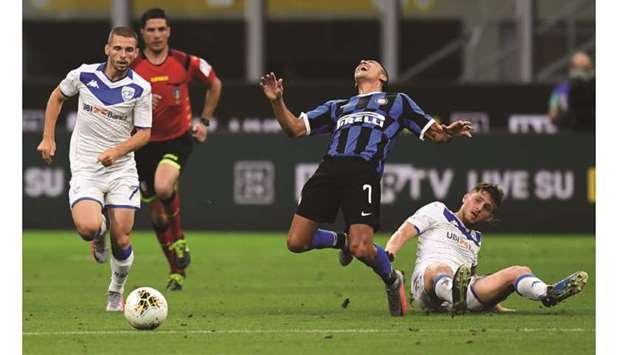 Inter Milanu2019s Alexis Sanchez (second right) is brought down by Bresciau2019s Alessandro Semprini (right) during the Italian Serie A match in Milan on Wednesday. (AFP)