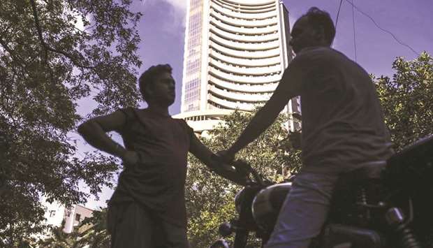 Pedestrians stand outside the Bombay Stock Exchange in Mumbai. The S&P BSE Sensex fell 0.9% to 37,736.07 yesterday, its lowest close since July 20.