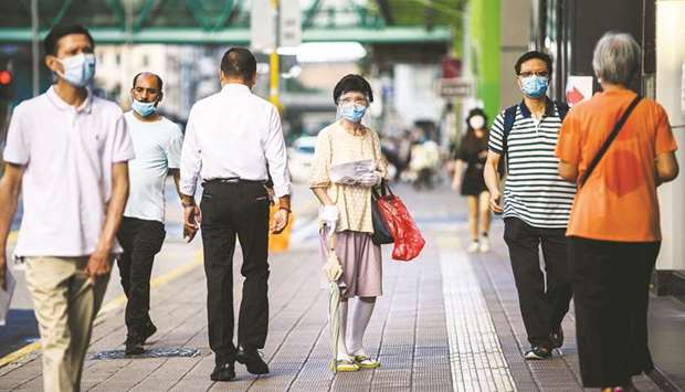 Pedestrians wear face masks in the Kowloon-side Sham Shui Po district of Hong Kong.