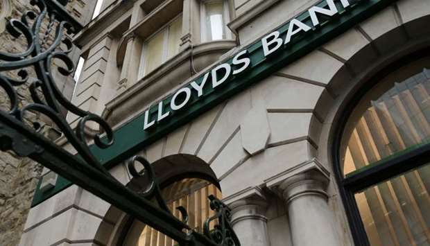 In this file photo taken on February 19, 2020 Signage for Lloyds Bank is pictured outside a branch in the City of London. Britain's Lloyds Banking Group on July 30, 2020 logged a first-half net loss after booking a vast u00a33.8-billion ($4.9-billion, 4.2-billion-euro) hit as coronavirus sparked a ,significant deterioration, in the outlook