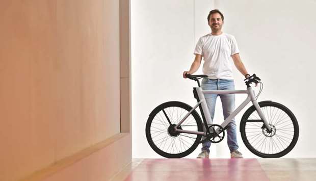 Founder and CEO of Cowboy Adrien Roose, a Belgian designer and manufacturer of electric bikes, poses with an electric bike at the companyu2019s headquarters in Brussels. Agnelli familyu2019s Exor holding company, the owner of Ferrari, has joined the race to invest in e-bikes with Belgian e-bike start-up Cowboy, as the two-wheeled electric commuter market shifts up a gear.