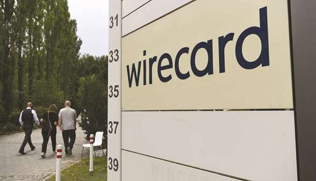 Visitors pass a sign at the entrance to the Wirecard headquarters in Munich. Pine Labs, the Indian payments company backed by Sequoia Capital and Mastercard Inc is interested in Wirecardu2019s regional point-of-sale business, which handles merchantsu2019 payments transactions, sources said.