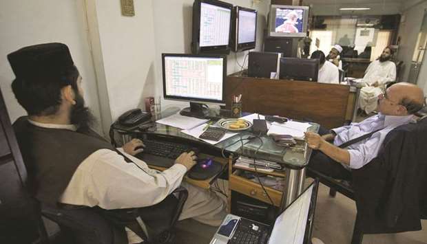 Traders work at the Pakistan Stock Exchange. The PSX announced that it will set up a fund to financially assist families of the martyred security personnel and those who were injured defending the exchange on June 29.