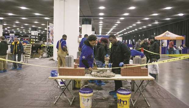 Officials demonstrate masonry techniques to job seekers during a construction career expo event in Detroit (file). The White unemployment rate fell 2.3 percentage points to 10.1% from 12.4% in June, while the rate for Blacks dropped 1.4 points to 15.4% from 16.8%, according to data released by the Labour Department.