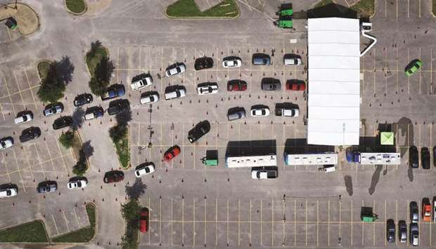 An aerial view from a drone shows people waiting in line at the drive-through Covid-19 testing centre at the Ellis Davis Field House, Dallas.