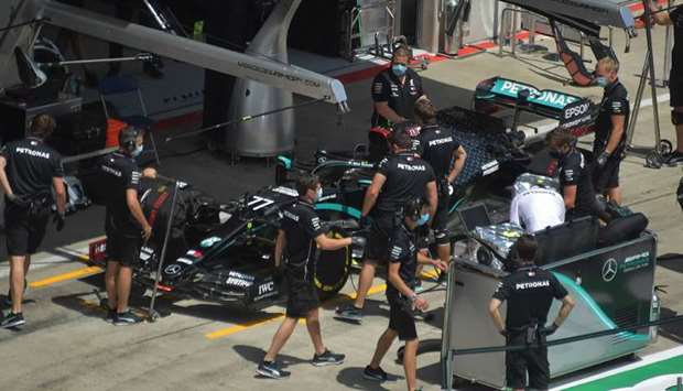 Mechanics work on the car of Mercedes driver Lewis Hamilton on the eve of the first practice session at the Austrian Grand Prix in Spielberg, Austria, yesterday. (AFP)