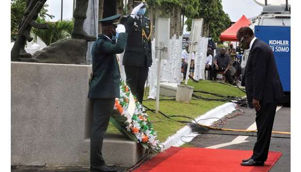 Ivory Coast President Alassane Ouattara attends a national tribute ceremony for soldiers in Abidjan yesterday.