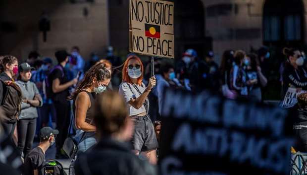 Protesters participate in a Black Lives Matter (BLM) rally, calling for an end to police brutality against Black people in the United States and First Nations people in Australia, in Brisbane, Australia