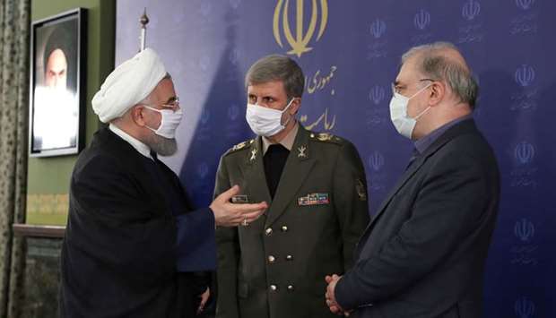 Iranian President Hassan Rouhani and Iranian Defense Minister Brigadier General Amir Hatami, wearing face masks during a meeting, in Tehran, Iran