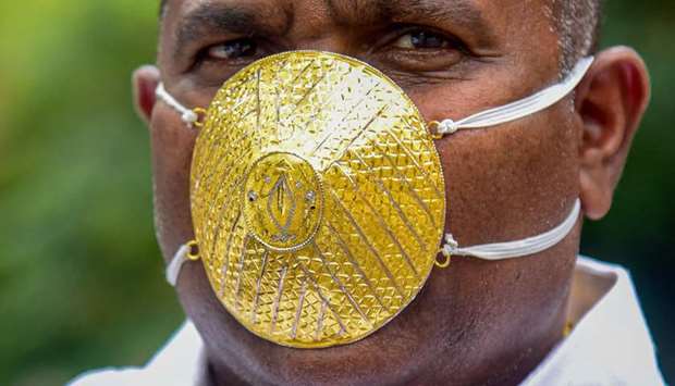 Indian man wears gold face mask to ward off coronavirus