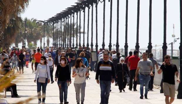People walk along Beirut's seaside Corniche (file)