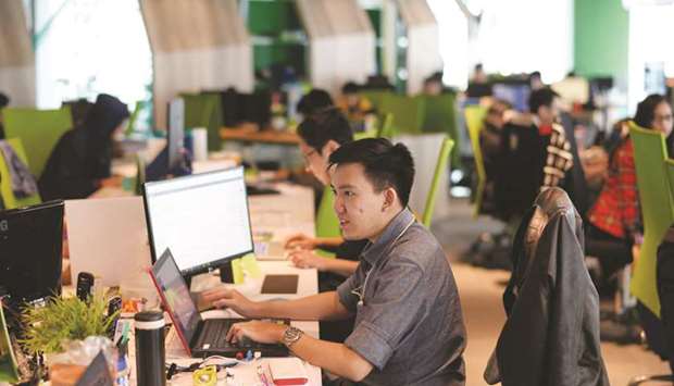 Employees work in front of computers at PT Tokopediau2019s office in Jakarta. Tokopedia co-founder and chief executive officer William Tanuwijaya built the countryu2019s most valuable startup after Gojek after scoring early backing from SoftBank founder Masayoshi Son and Alibaba Group Holding co-founder Jack Ma.