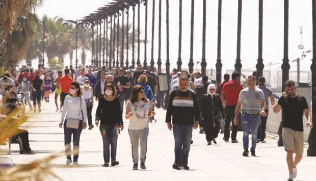 People walk along Beirutu2019s seaside Corniche (file). The IMF warned Lebanon that its economic implosion is accelerating and told authorities to act urgently to pull the country back from crisis.
