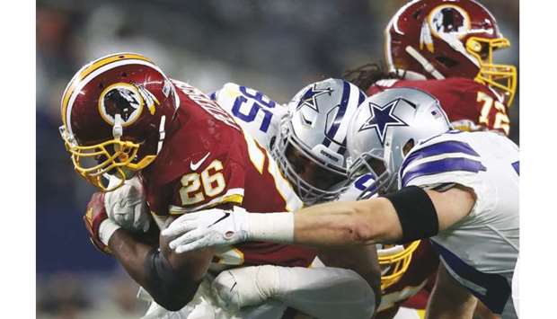 Adrian Peterson (left) of the Washington Redskins in action during their NFL game against the Dallas Cowboys at AT&T Stadium in Arlington, Texas, on December 29, 2019. (AFP)