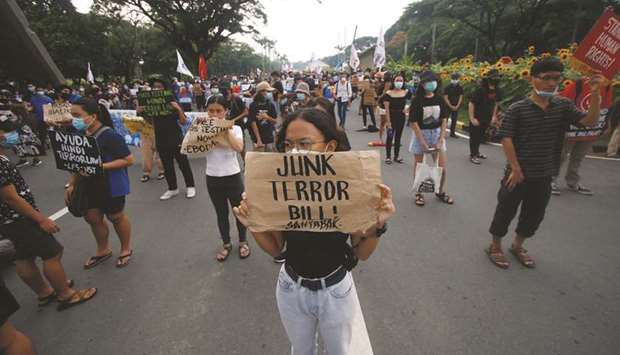 A protester raises a placard that says u201cOust Duterteu201d during a rally against the anti-terror bill that was approved by President Rodrigo Duterte the day before, in Quezon City, Metro Manila.