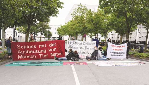 Activists protest outside the Tonnies slaughterhouse in Rheda-Wiedenbrueck, Germany.