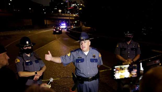 Washington State Patrol Capt. Ron Mead briefs media near the scene where two people in a group of protesters were struck by a car on Interstate 5 while the highway was closed to traffic due to the protest in Seattle, Washington