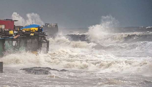 Waves hit structures built along the coast during monsoon rains in Mumbai yesterday.