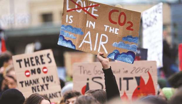A climate change activist holds a sign during a demonstration of the Fridays for Future movement in Lausanne, Switzerland, in this January 17, 2020 photograph.