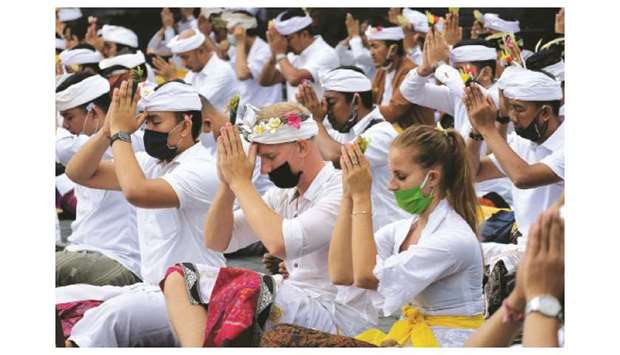 People attend mass prayers, expressing gratitude for the handling of the new coronavirus and seeking blessings for the start of a u201cnew normalu201d, in Karangasem, Bali yesterday.