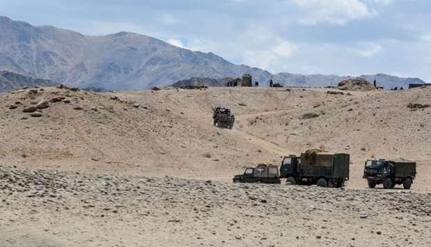 Indian Army personnel drive vehicles as they take part in a war exercise at Thikse in Leh district of the union territory of Ladakh on July 4