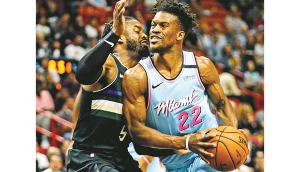 The Miami Heatu2019s Jimmy Butler (right) drives against the Milwaukee Bucksu2019 Wesley Matthews at the AmericanAirlines Arena in Miami on March 2, 2020. (TNS)