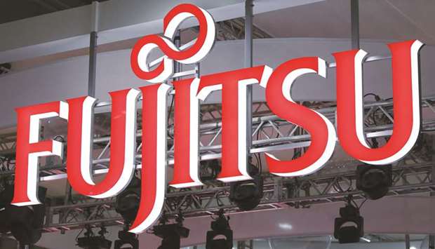 The Fujitsu logo is displayed at the companyu2019s booth at the Cutting-Edge IT & Electronics Comprehensive Exhibition in Chiba, Japan. The company said it will cut its office space in Japan by 50% over the next three years, encouraging 80,000 office workers to primarily work from home in what it termed a u201cWork Life Shift for the new normal.u201d