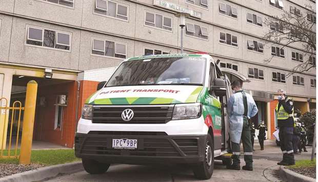 A patient transport vehicle prepares to transport a resident from one of nine public housing estates locked down due a spike in Covid-19 coronavirus numbers in Melbourne yesterday. Australia will effectively seal off the state of Victoria from the rest of the country, authorities said yesterday, announcing unprecedented measures to tackle a worrying surge in coronavirus cases.
