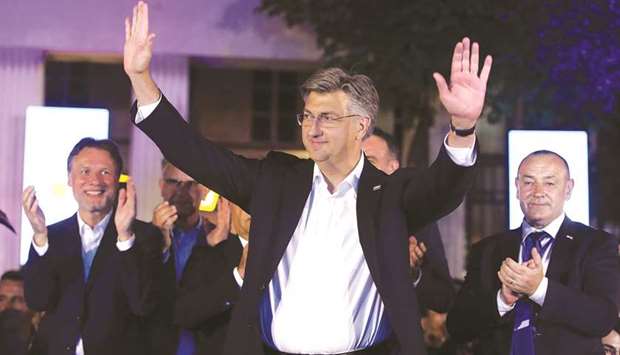 Croatian Prime Minister and leader of the Croatian Democratic Union party (HDZ) Andrej Plenkovic celebrates with party members after declaring victory in parliamentary elections at the garden of the Archaeological Museum in Zagreb on Sunday night.