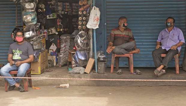Shopkeepers wait for customers at a second hand automobile spare market in Chennai yesterday.