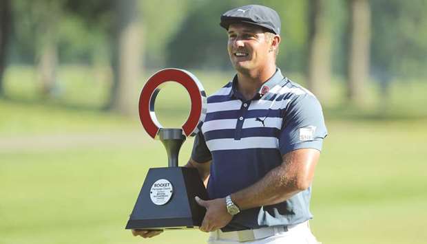 Bryson DeChambeau celebrates with the trophy after winning the Rocket Mortgage Classic at the Detroit Golf Club. (AFP)
