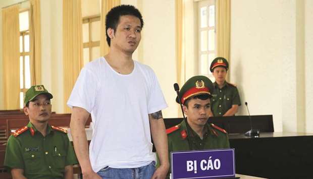 Nguyen Quoc Duc Vuong (centre) during his court trial in Vietnamu2019s Lam Dong province yesterday.