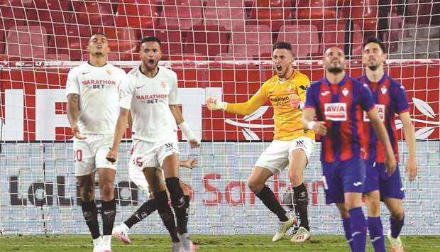 Sevillau2019s midfielder Lucas Ocampos (centre) celebrates stopping a shot after replacing injured goalkeeper Tomas Vaclik during La Liga match against Eibar. (AFP)