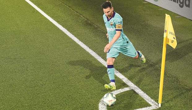 Lionel Messi takes a corner during a La Liga match against Villarreal at the Madrigal stadium in Villarreal on July 5.