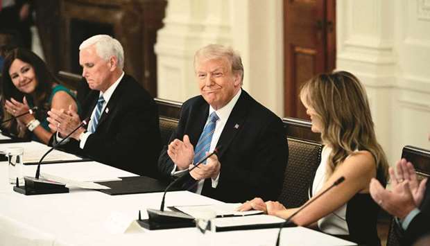 (From left) Vice President Mike Pence, President Donald Trump and First Lady Melania Trump attend a roundtable discussion on the Safe Reopening of Americau2019s Schools during the coronavirus pandemic, at the White House on in Washington, DC, on Tuesday.