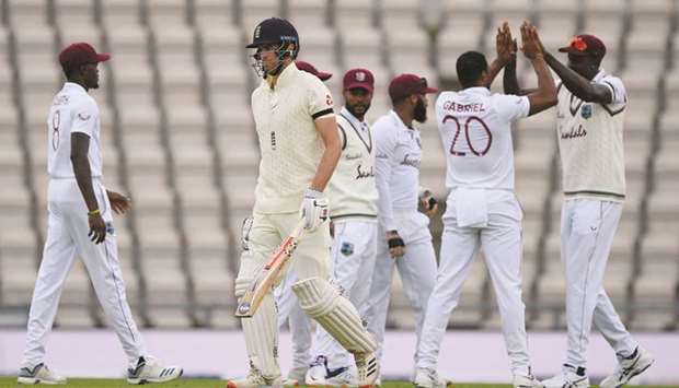 West Indies fast bowler Shannon Gabriel (second right) celebrates dismissing Englandu2019s Dom Sibley (second left) on day one of the first Test at the Ageas Bowl in Southampton yesterday. (AFP)